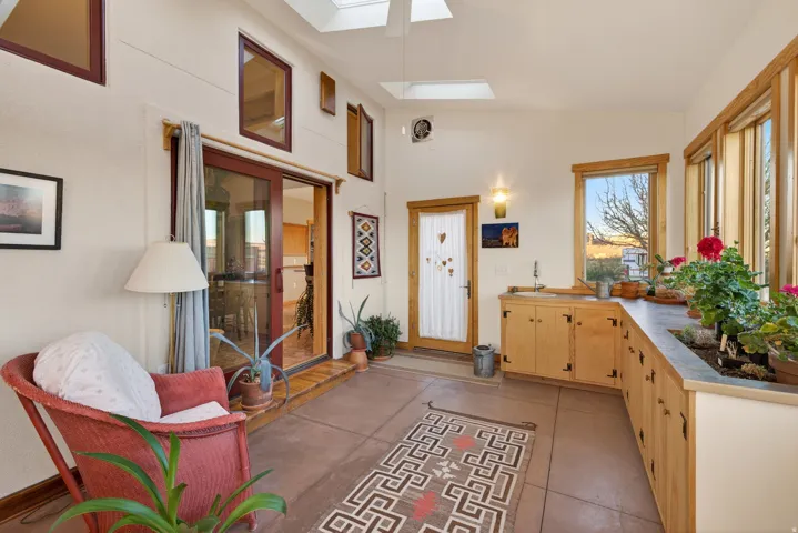 Sunroom featuring a skylight and vaulted ceiling