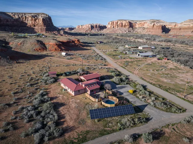 Aerial overview of property's location featuring a mountainous background and rural landscape