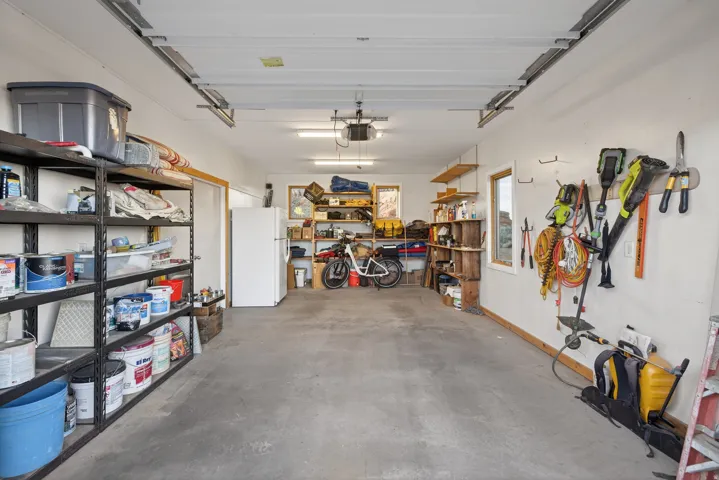 Garage featuring freestanding refrigerator