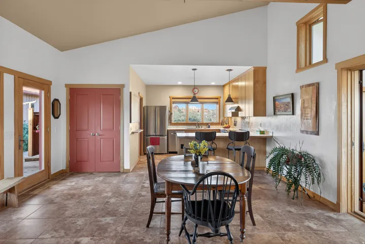 Dining area featuring lofted ceiling and baseboards