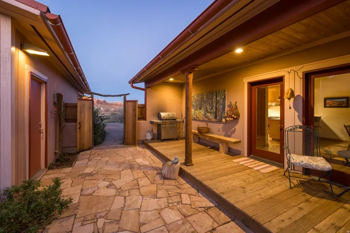 Patio terrace at dusk featuring a grill, a gate, and a patio
