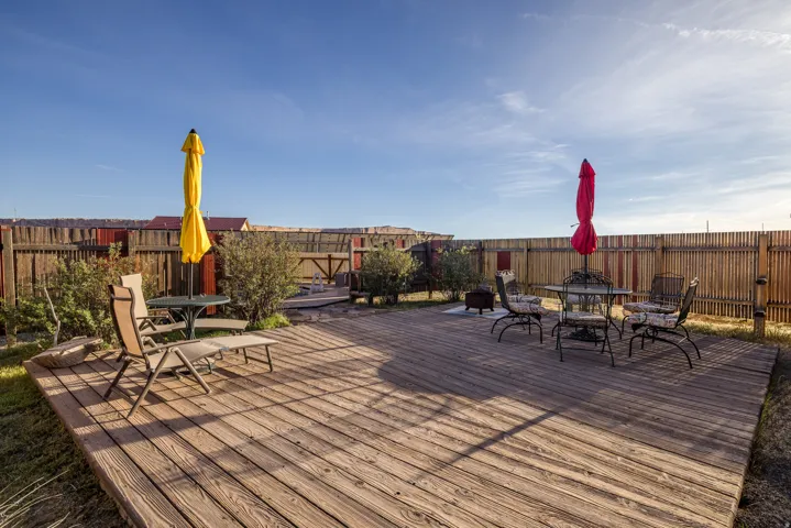 Deck with outdoor dining area and a fenced backyard