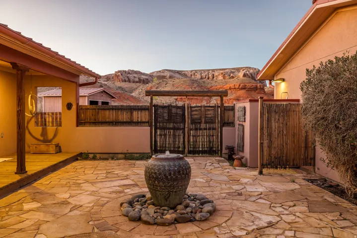 Fenced backyard with a patio, a mountain view, and a gate