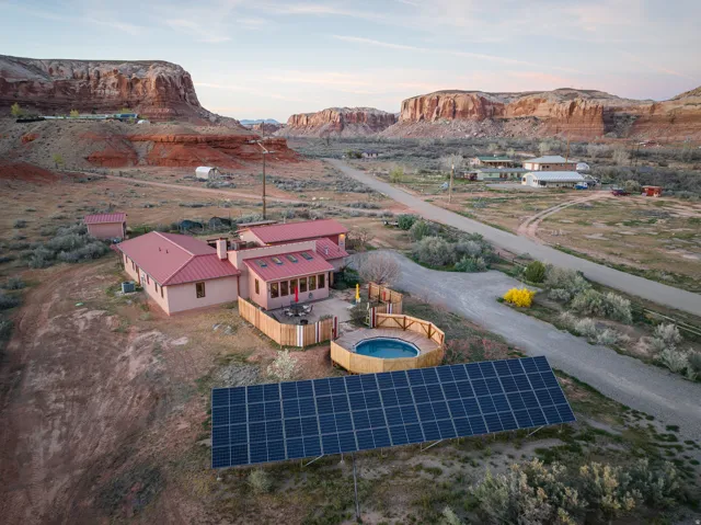 View of subject property featuring a mountainous background and a pool area