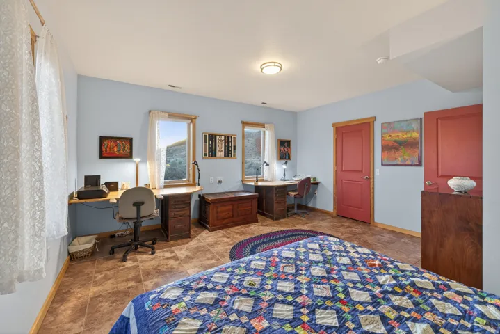 Bedroom featuring baseboards and built in desk