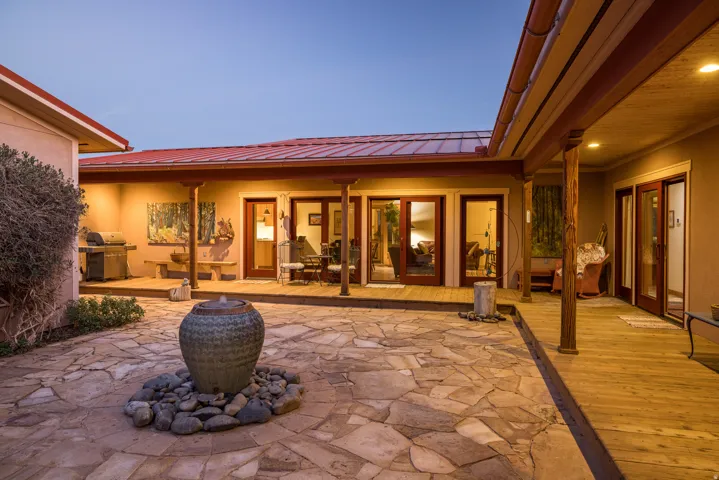 View of patio with grilling area, a wooden deck, and outdoor dining area