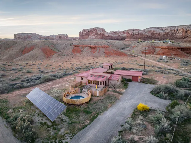 Aerial view of property and surrounding area with a mountain backdrop and a desert landscape