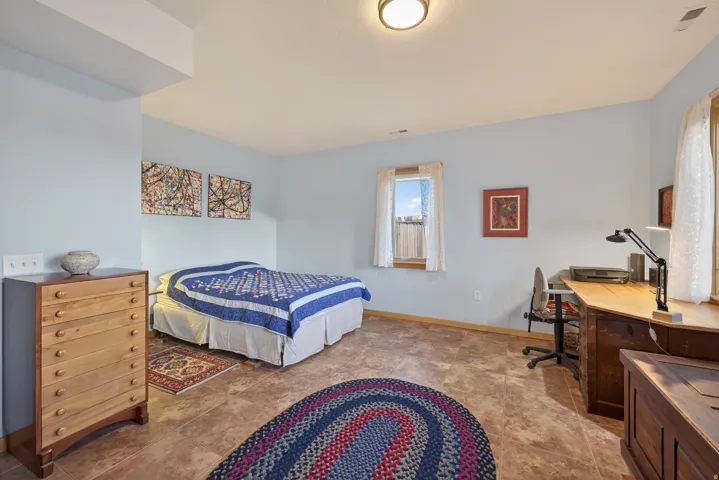 Bedroom with a desk and baseboards