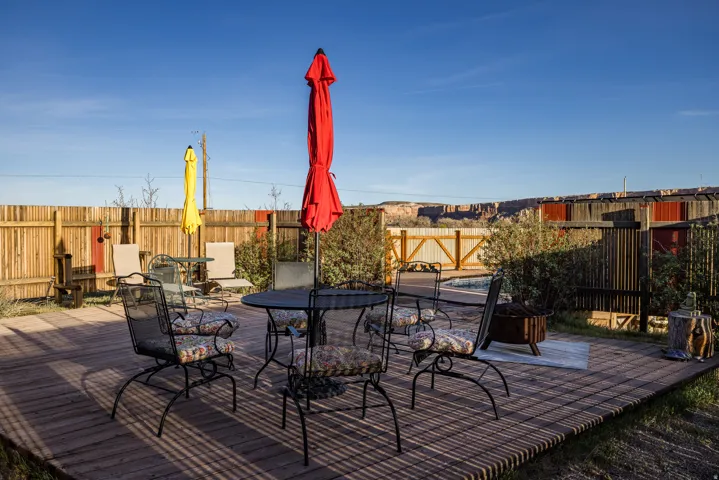 Deck with a fenced backyard and outdoor dining area