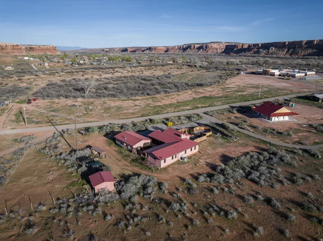 Aerial view of property and surrounding area with rural landscape and a mountainous background