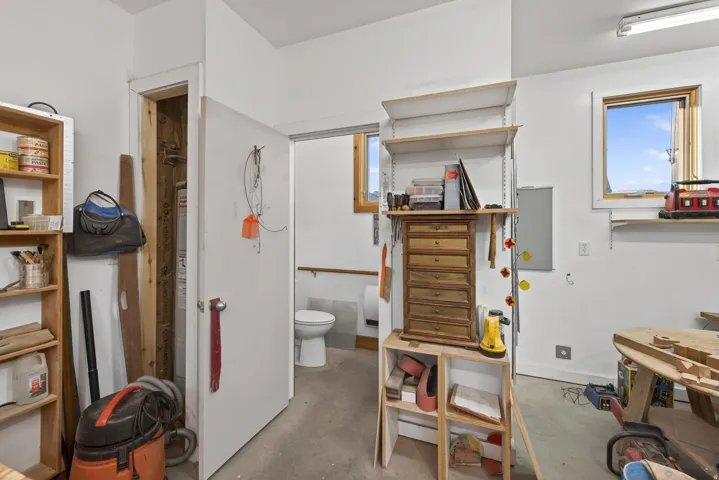 Bathroom with toilet and concrete flooring