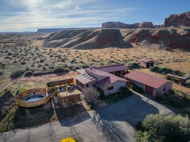 Aerial view of property and surrounding area featuring a desert landscape and mountains