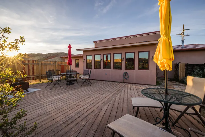 Deck with outdoor dining area and a fenced backyard