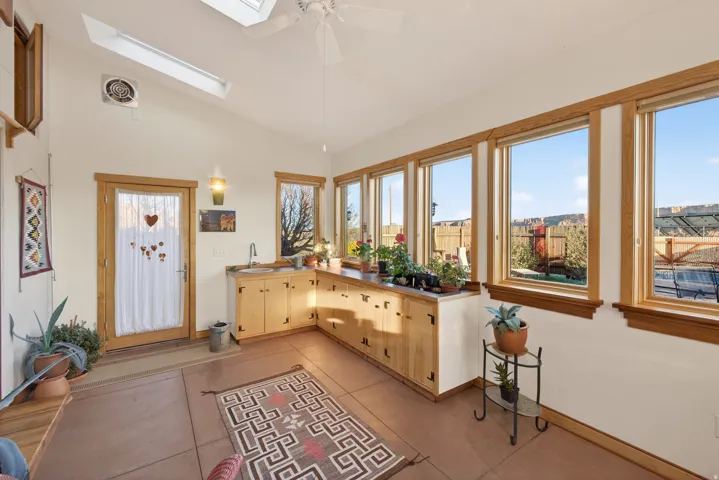 Sunroom featuring a skylight and vaulted ceiling