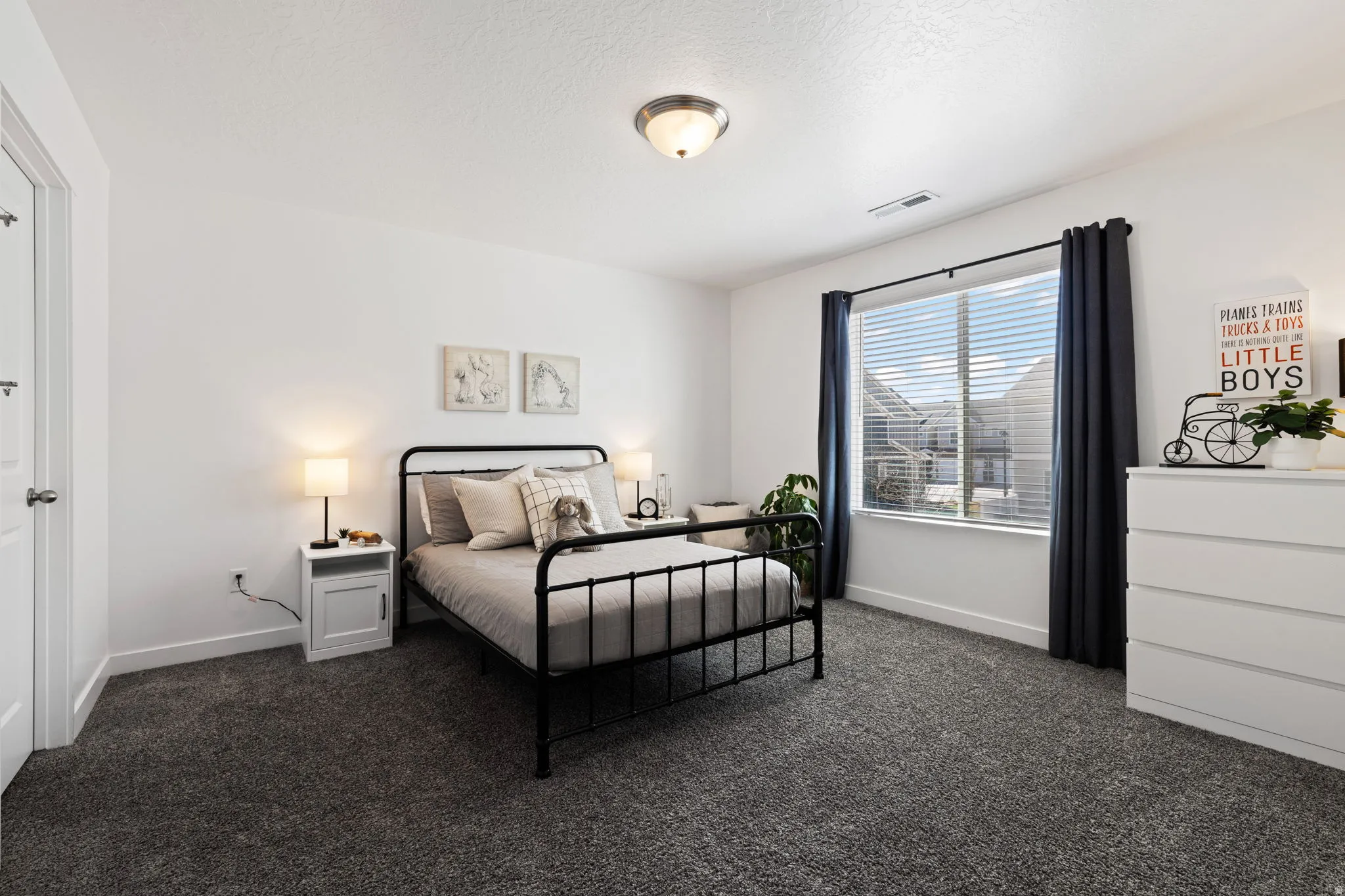 Bedroom featuring dark colored carpet