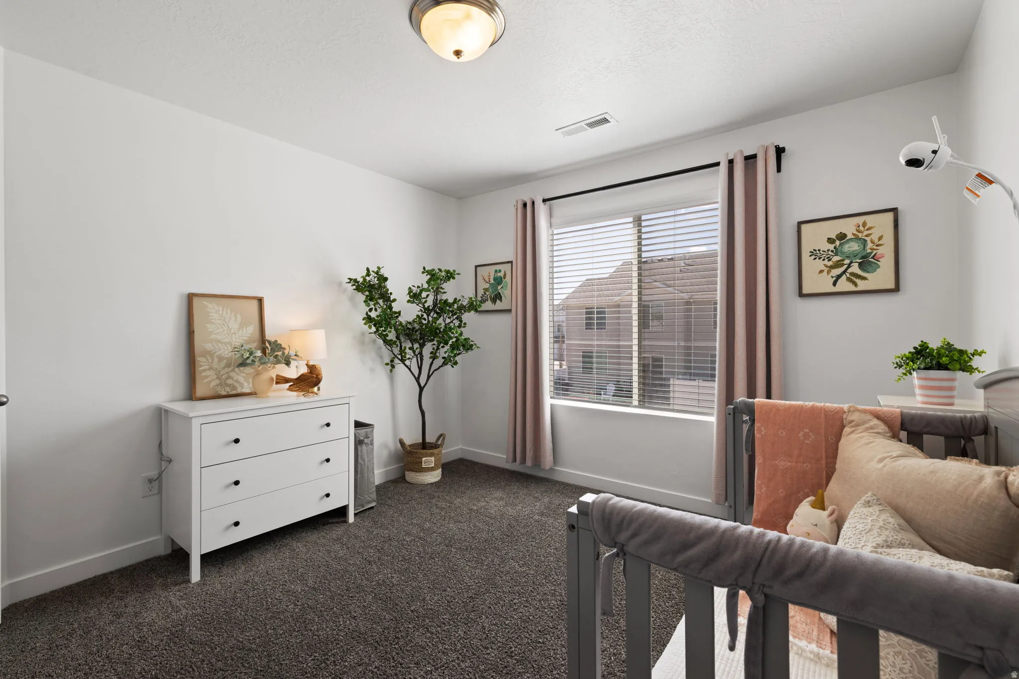 Bedroom with baseboards and dark carpet