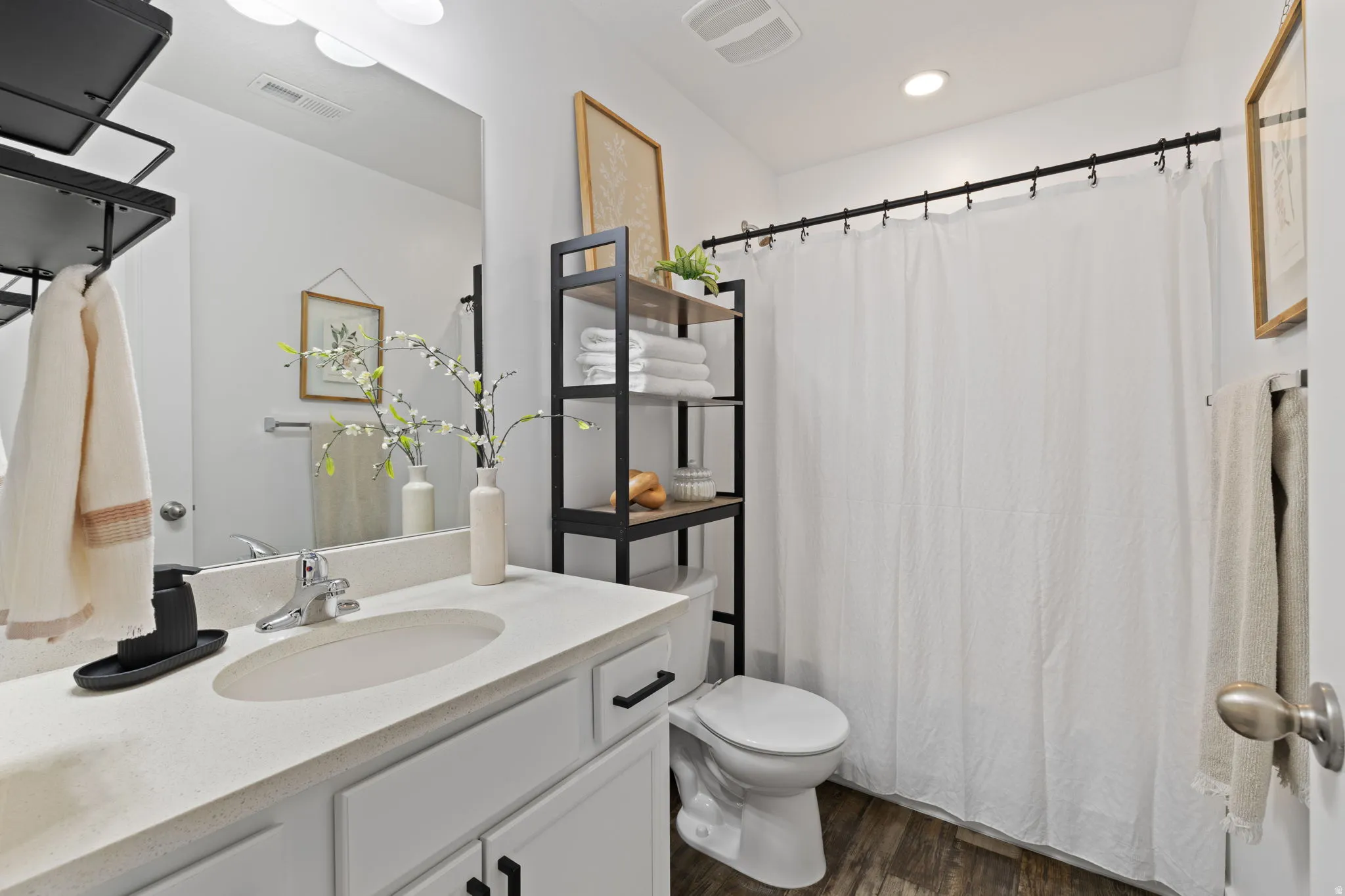 Bathroom featuring vanity and dark wood-style flooring