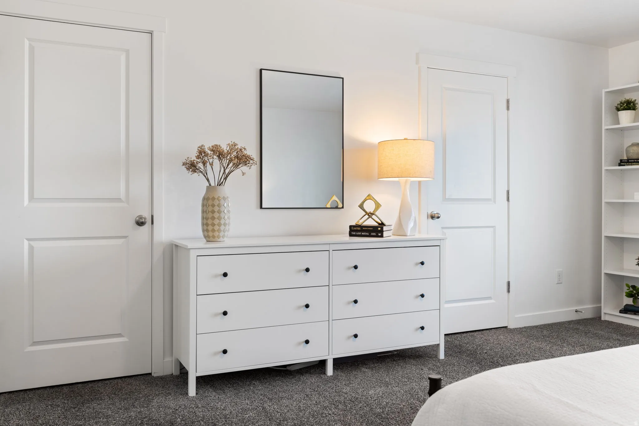 Bedroom with dark carpet and baseboards