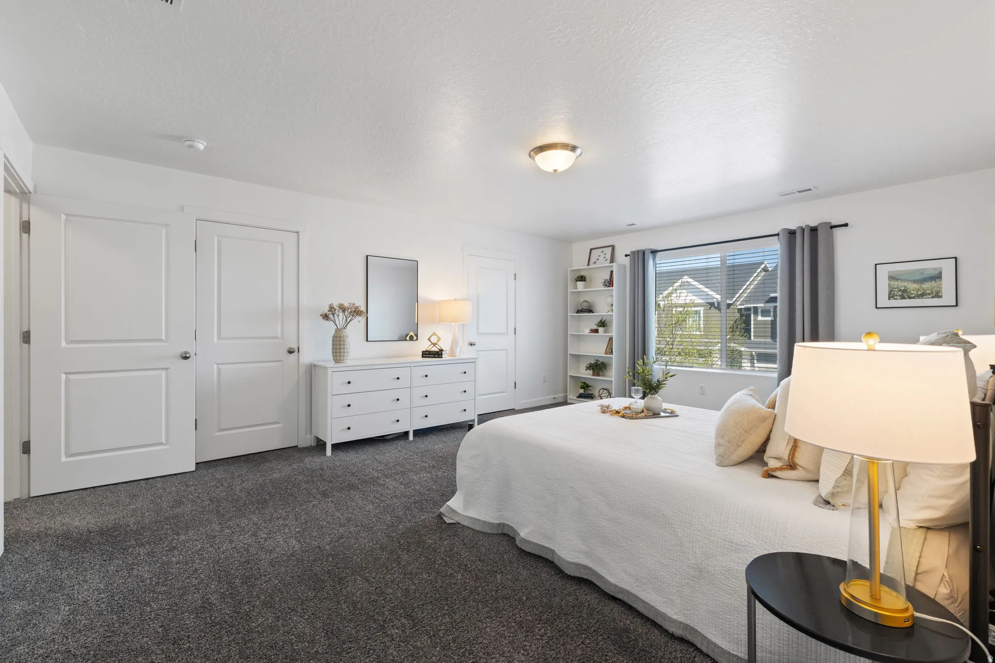 Bedroom featuring dark carpet and a textured ceiling