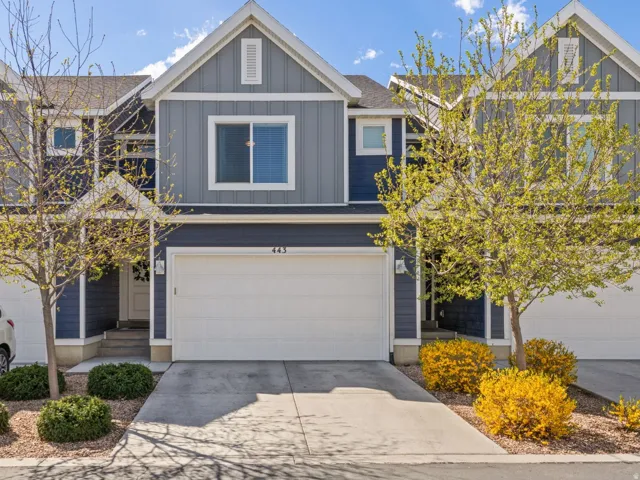 Craftsman-style home with board and batten siding, concrete driveway, and a garage