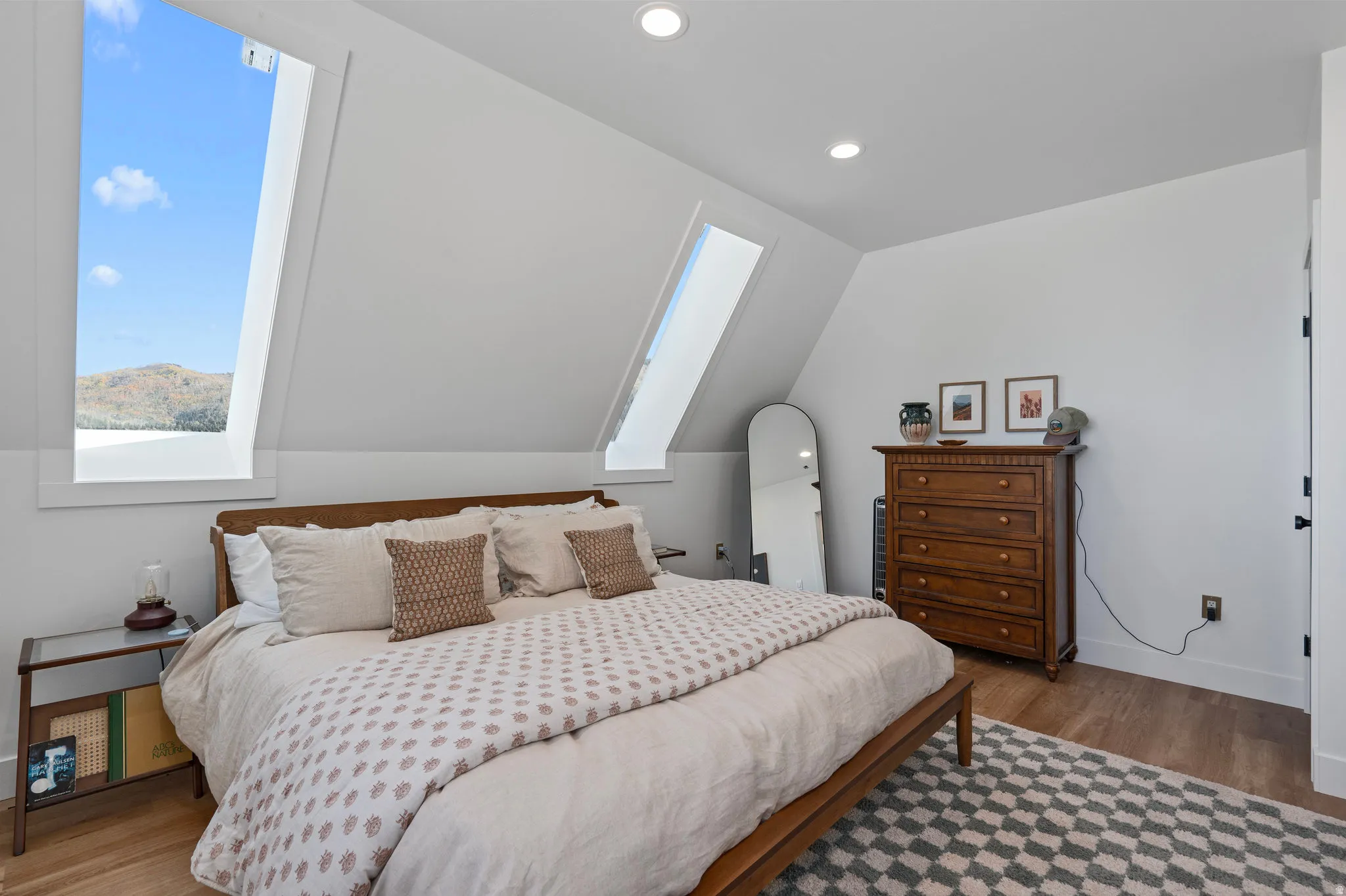 Bedroom featuring light wood-type flooring, recessed lighting, and lofted ceiling