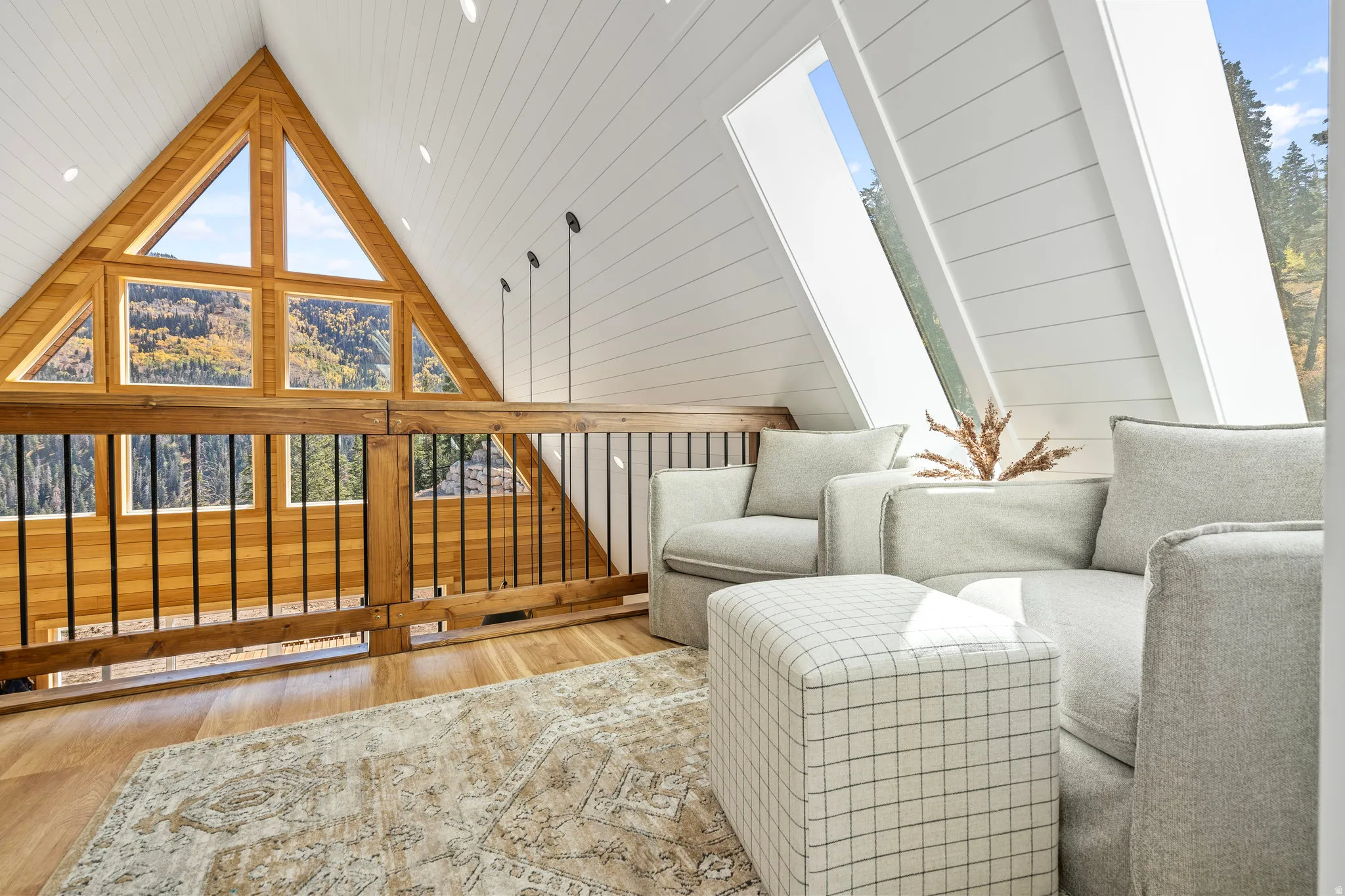 Living area with wood finished floors, healthy amount of natural light, wooden walls, and wood ceiling