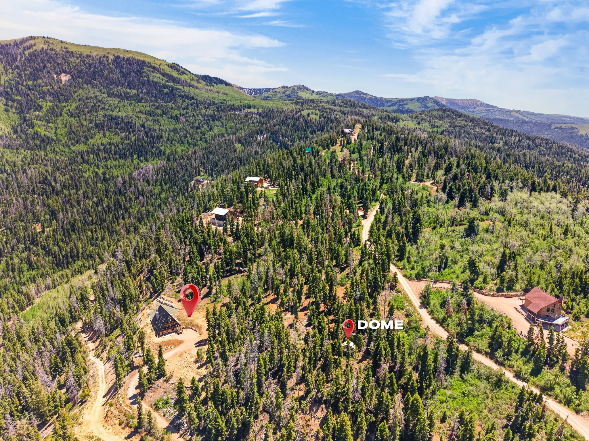 Mountainous terrain featuring dense evergreen and deciduous trees