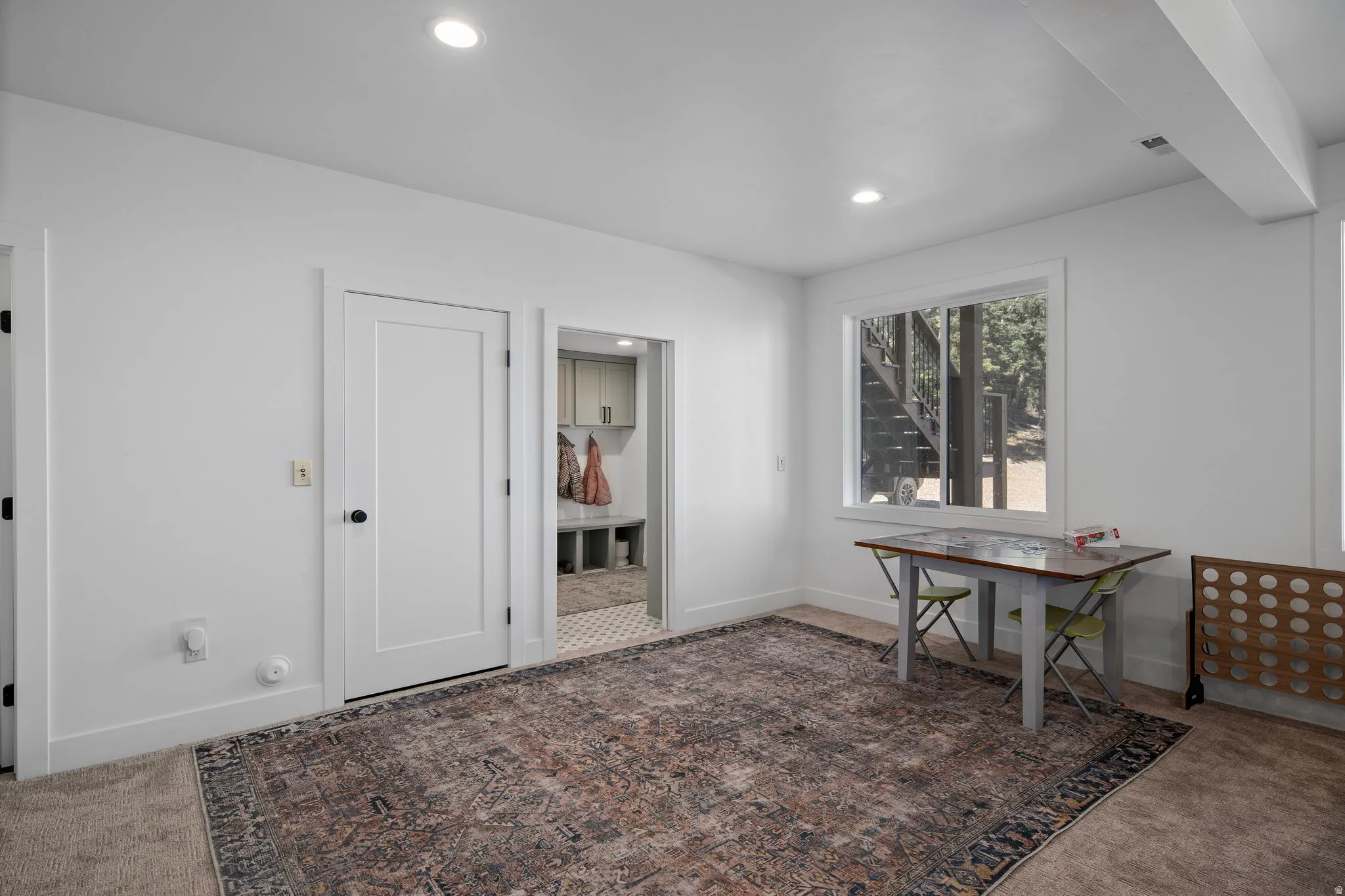 Home office with dark carpet and recessed lighting