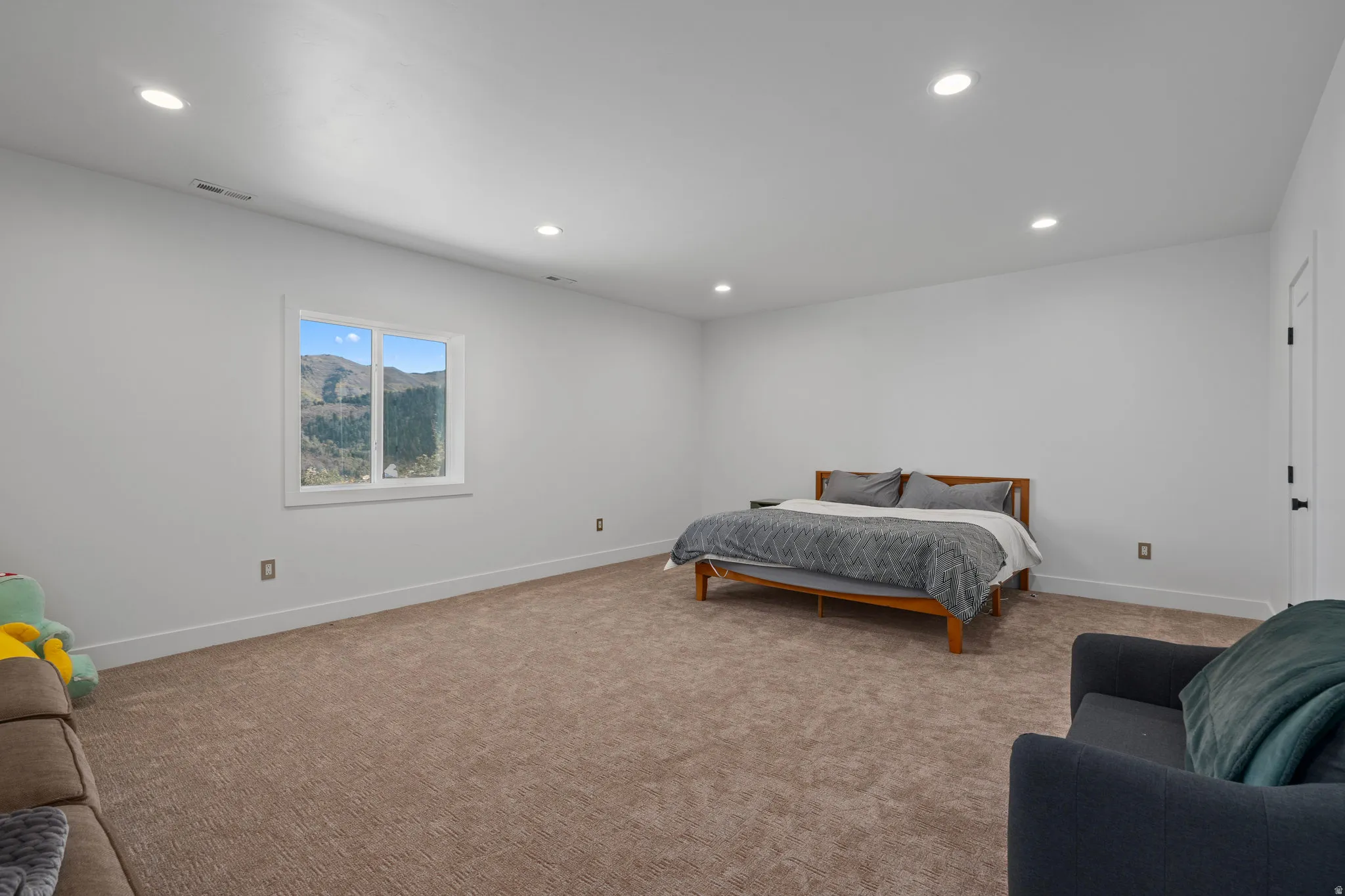 Bedroom featuring light carpet and recessed lighting