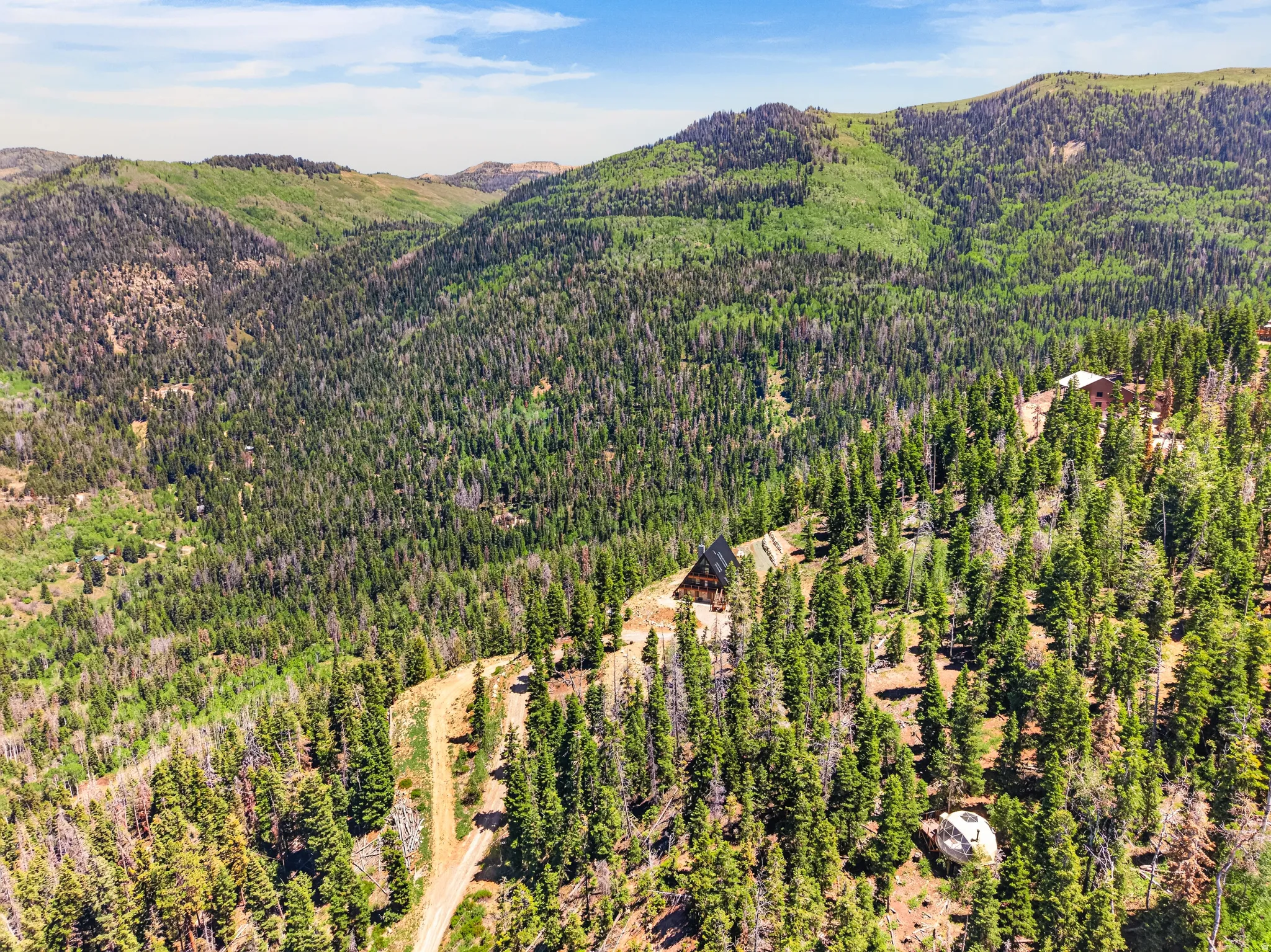 Sprawling mountain landscape featuring extensive tree coverage