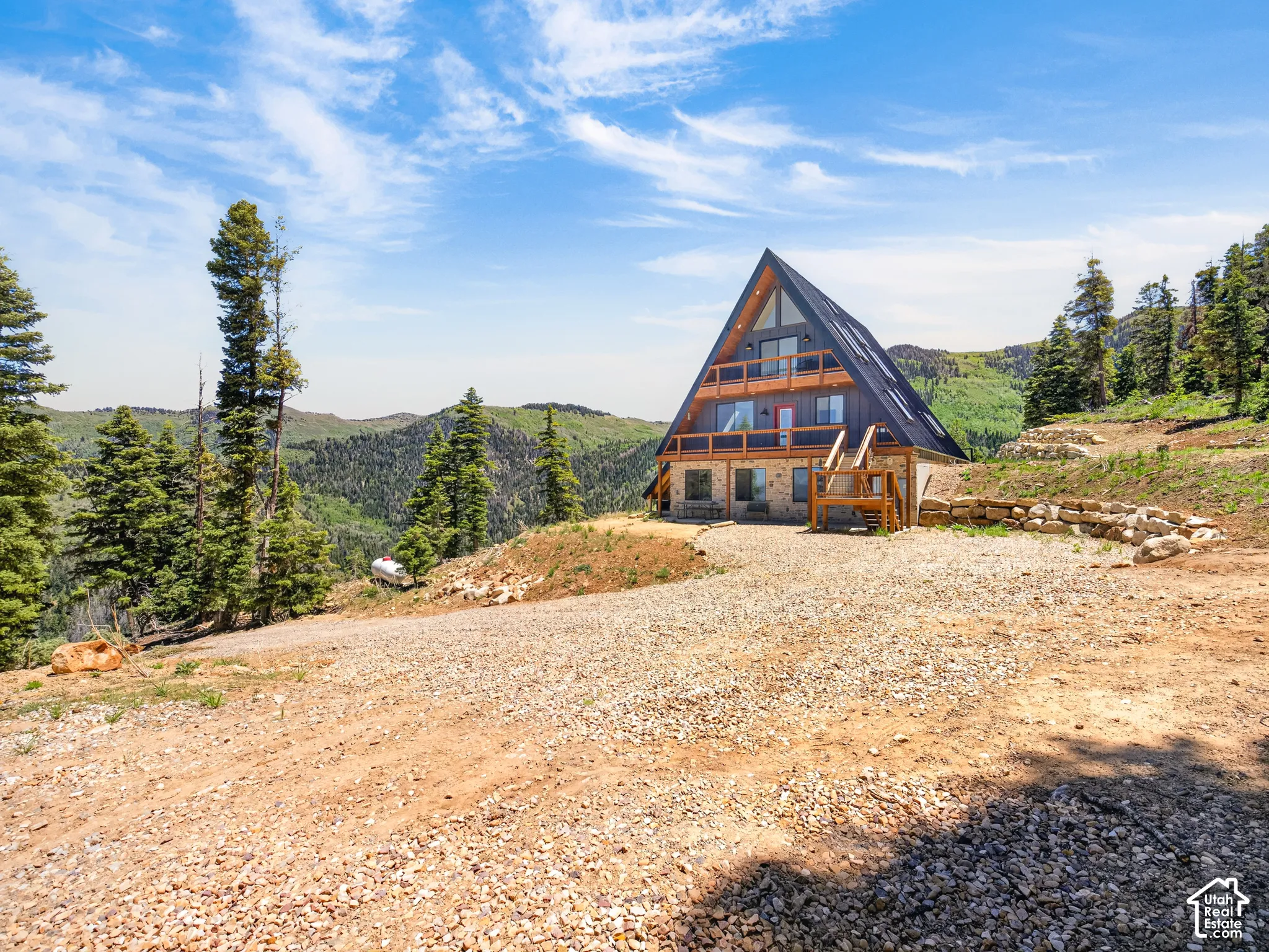 A-frame residence featuring a dark-pitched roof and light-toned siding