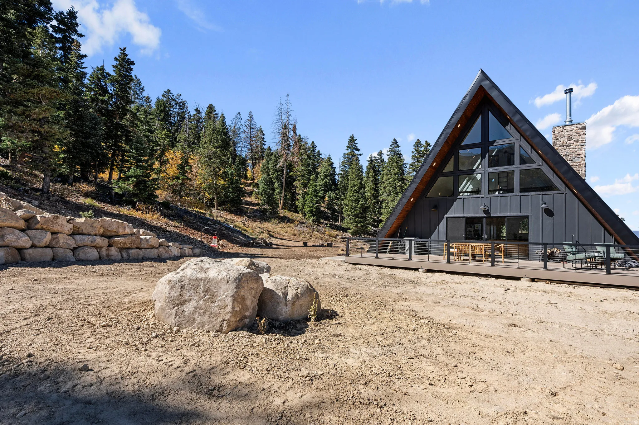 Exterior space featuring a wooden deck, a chimney, and board and batten siding