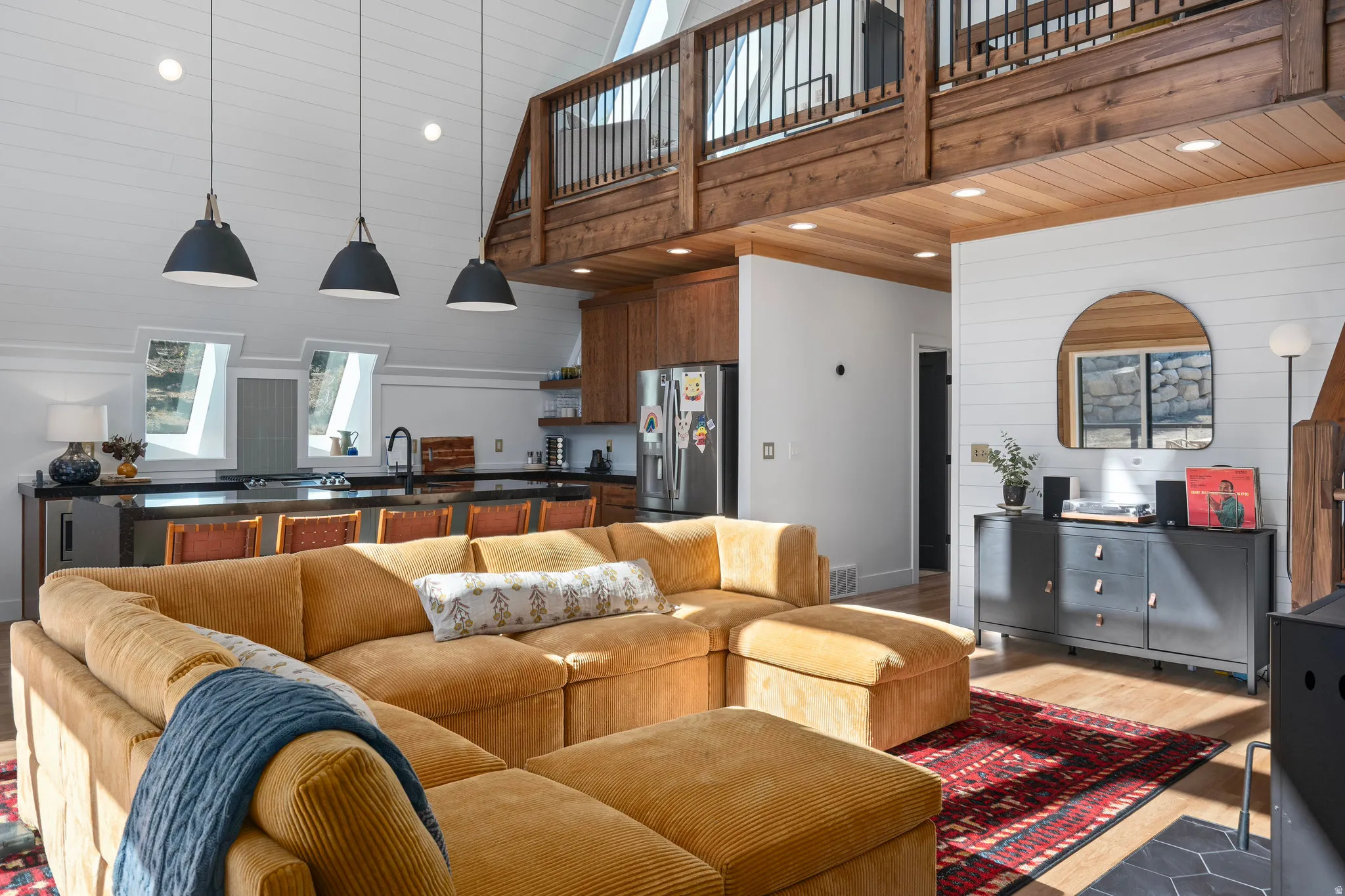 Living area with wooden walls, wood finished floors, recessed lighting, and a high wood ceiling
