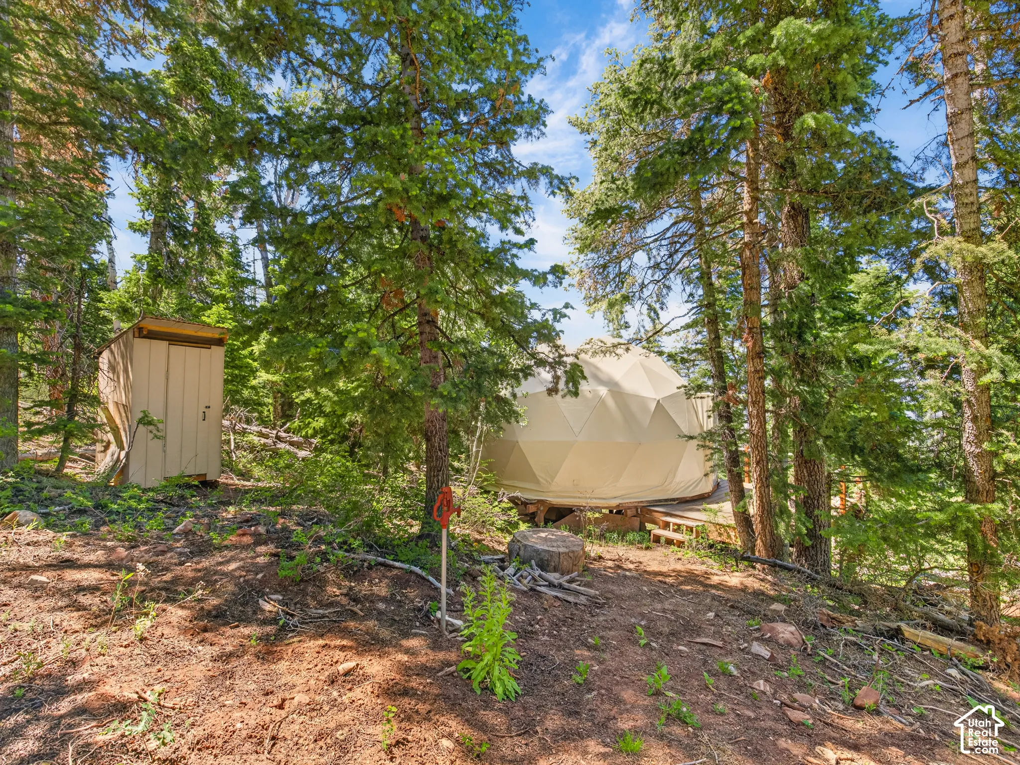 Dome structure with a beige exterior, elevated on a wooden platform