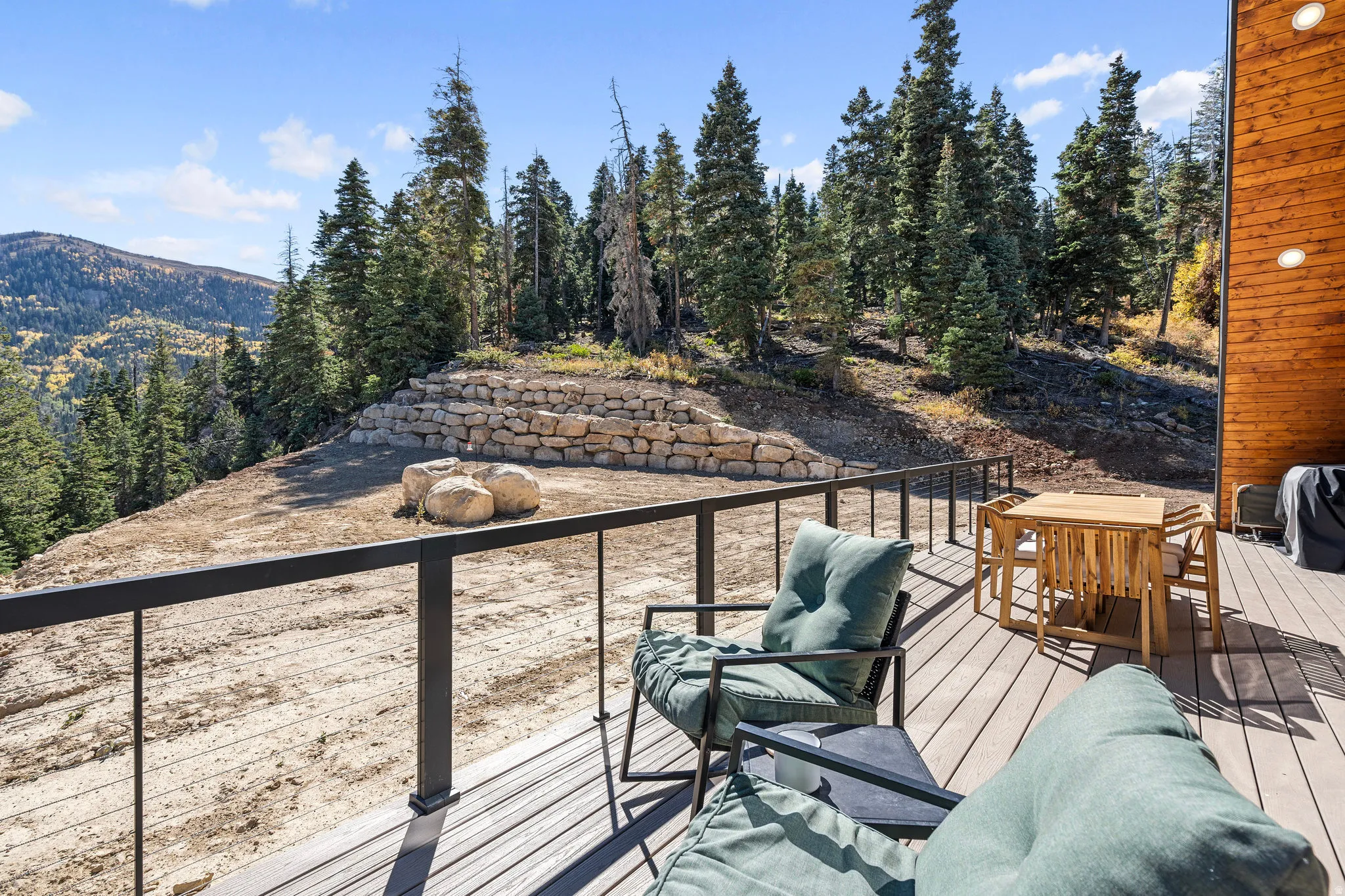 Deck with outdoor dining area and a mountain view