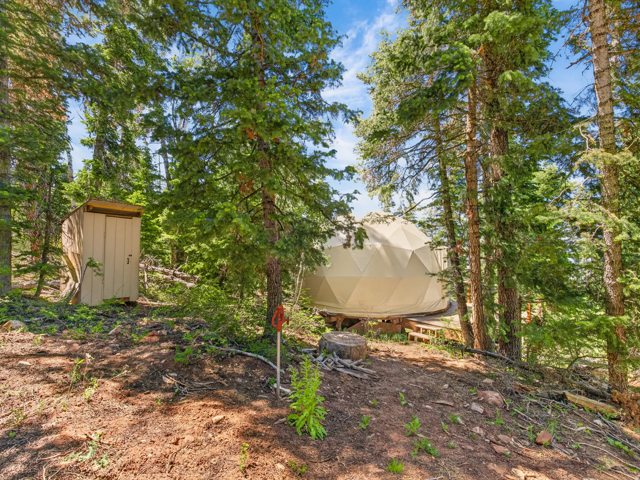 Dome structure with a beige exterior, elevated on a wooden platform
