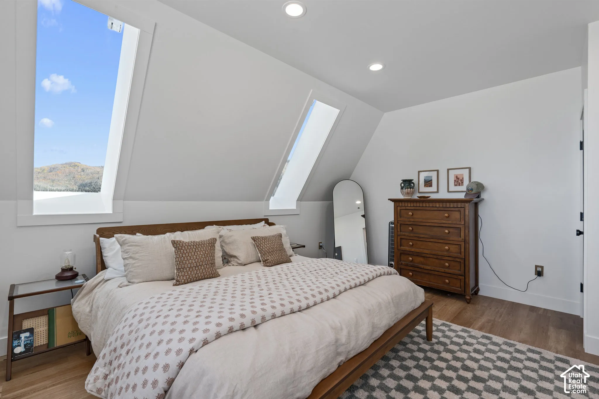 Bedroom featuring light wood-type flooring, recessed lighting, and lofted ceiling