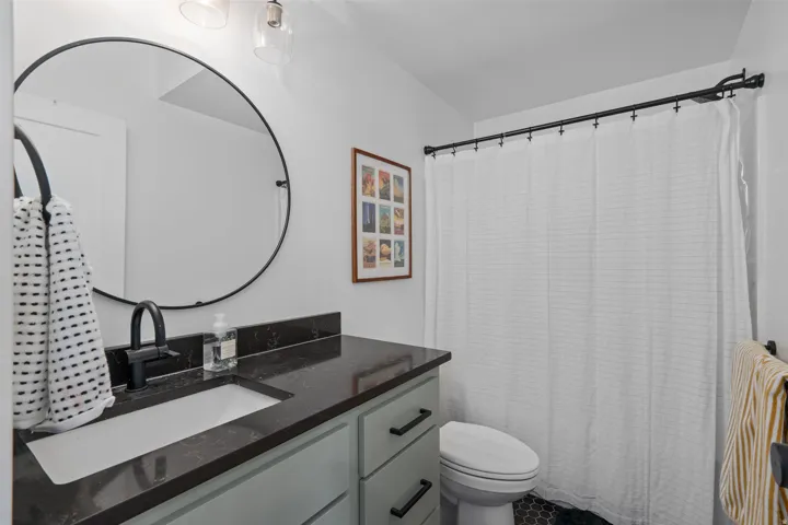 Full bath featuring vanity and toilet