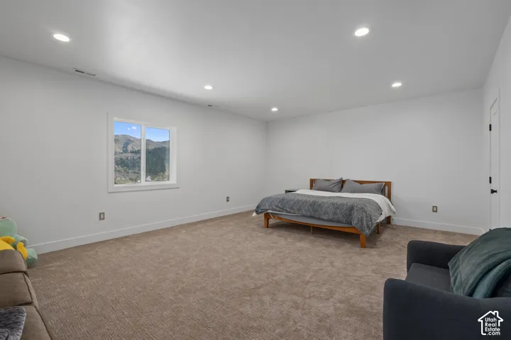 Bedroom featuring light carpet and recessed lighting