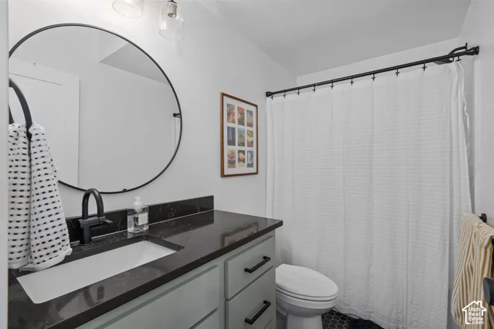 Full bath featuring vanity and toilet