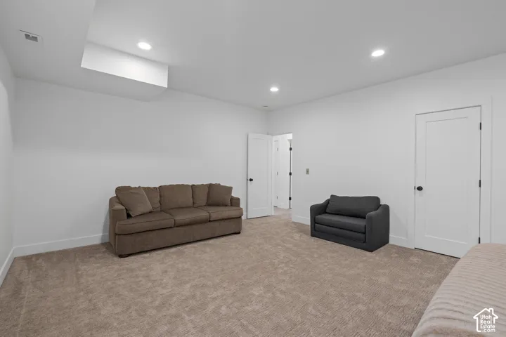 Living room with recessed lighting and light colored carpet