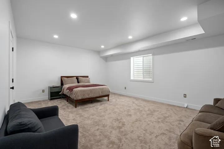 Bedroom featuring recessed lighting and light carpet