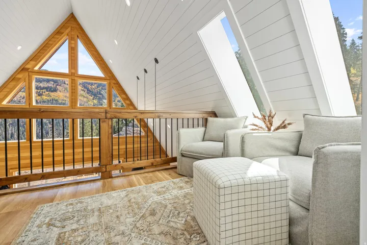 Living area with wood finished floors, healthy amount of natural light, wooden walls, and wood ceiling