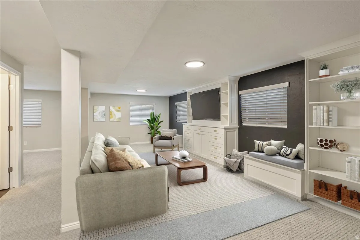 Living area featuring light carpet and baseboards