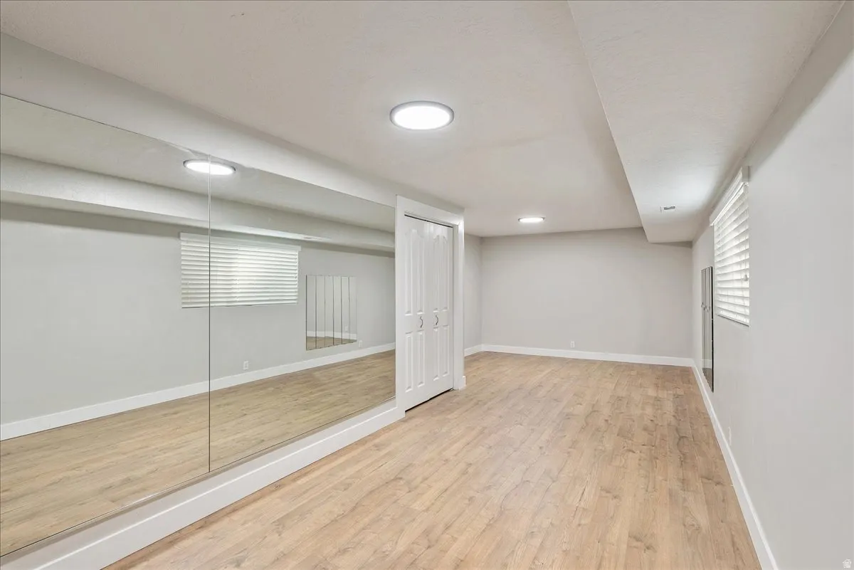 Unfurnished bedroom featuring light wood finished floors and a closet