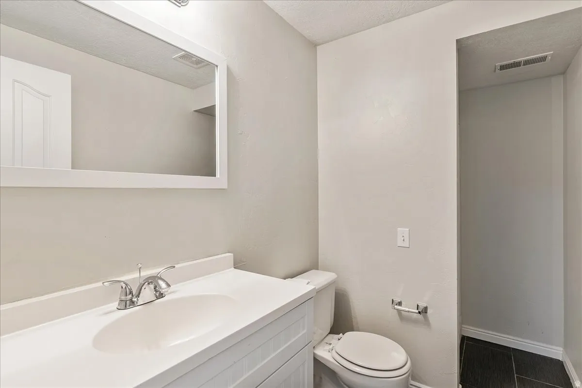 Bathroom with vanity and a textured ceiling