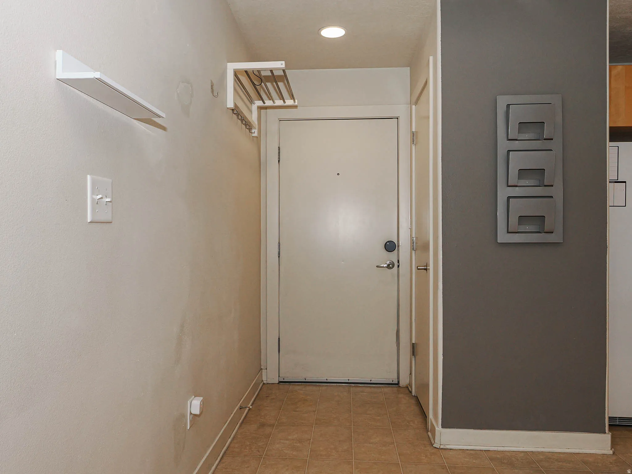 Doorway featuring baseboards and recessed lighting