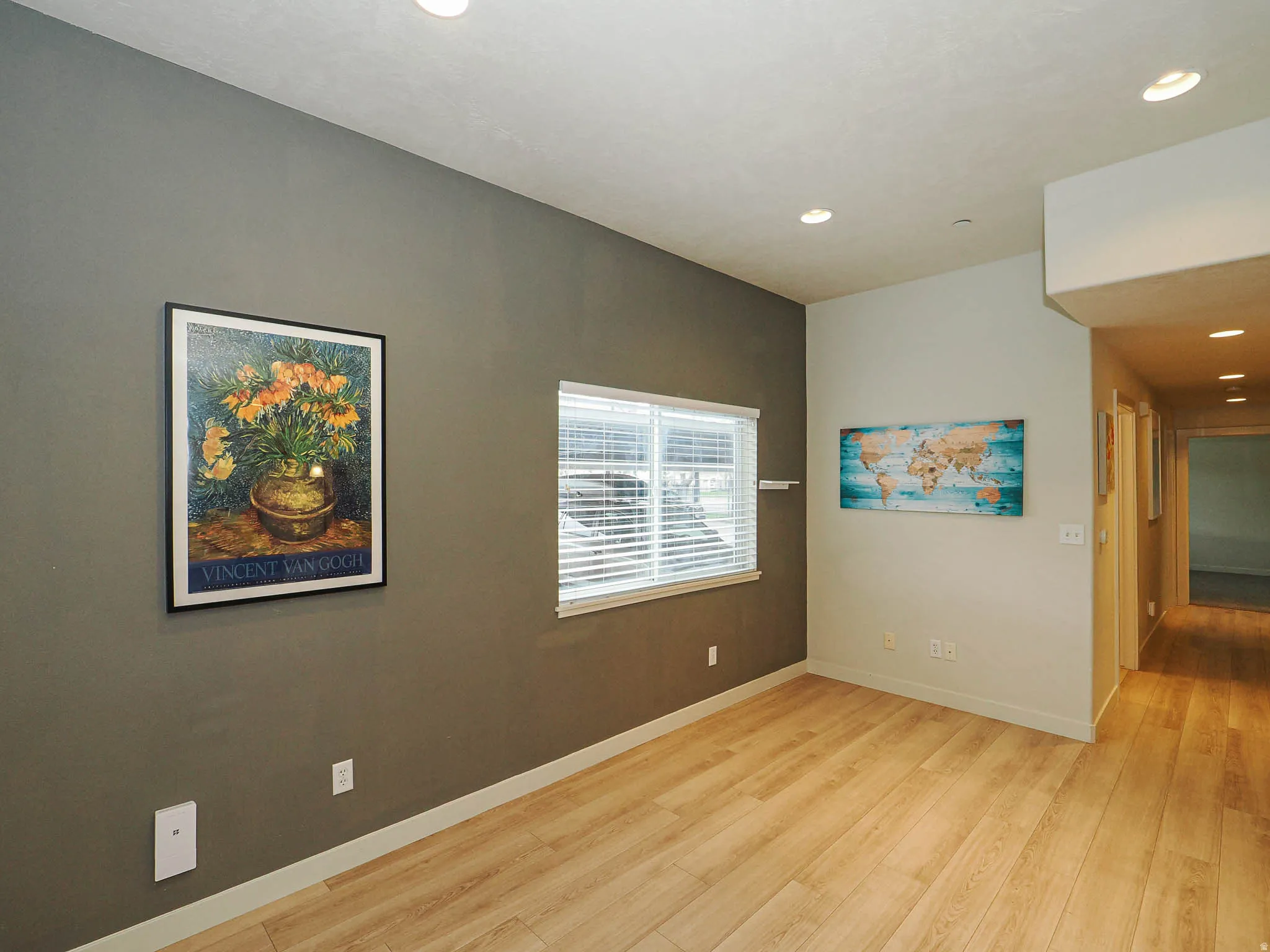 Empty room featuring light wood-style flooring and recessed lighting