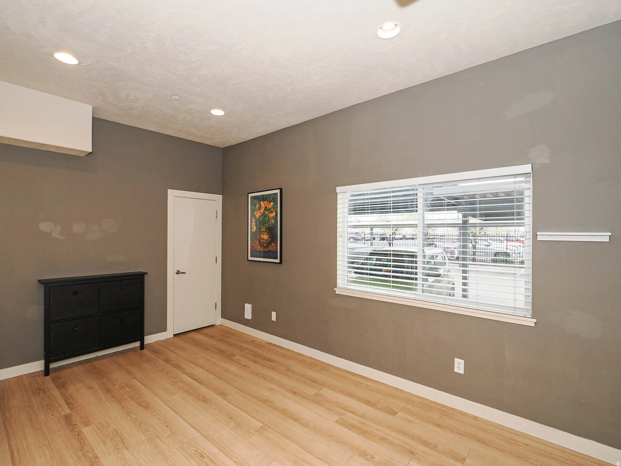 Empty room with light wood-type flooring and recessed lighting