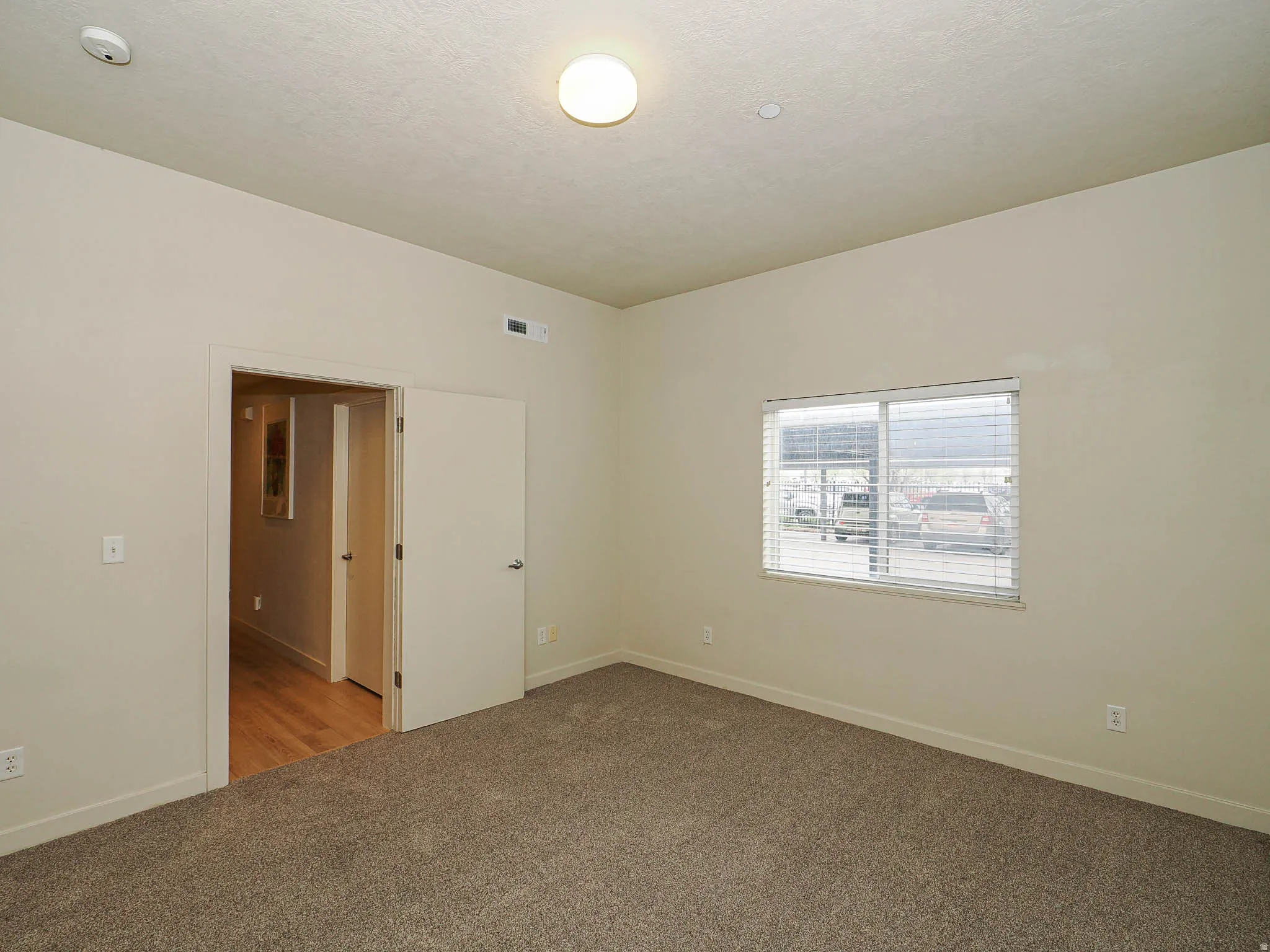 Unfurnished room with carpet floors and baseboards